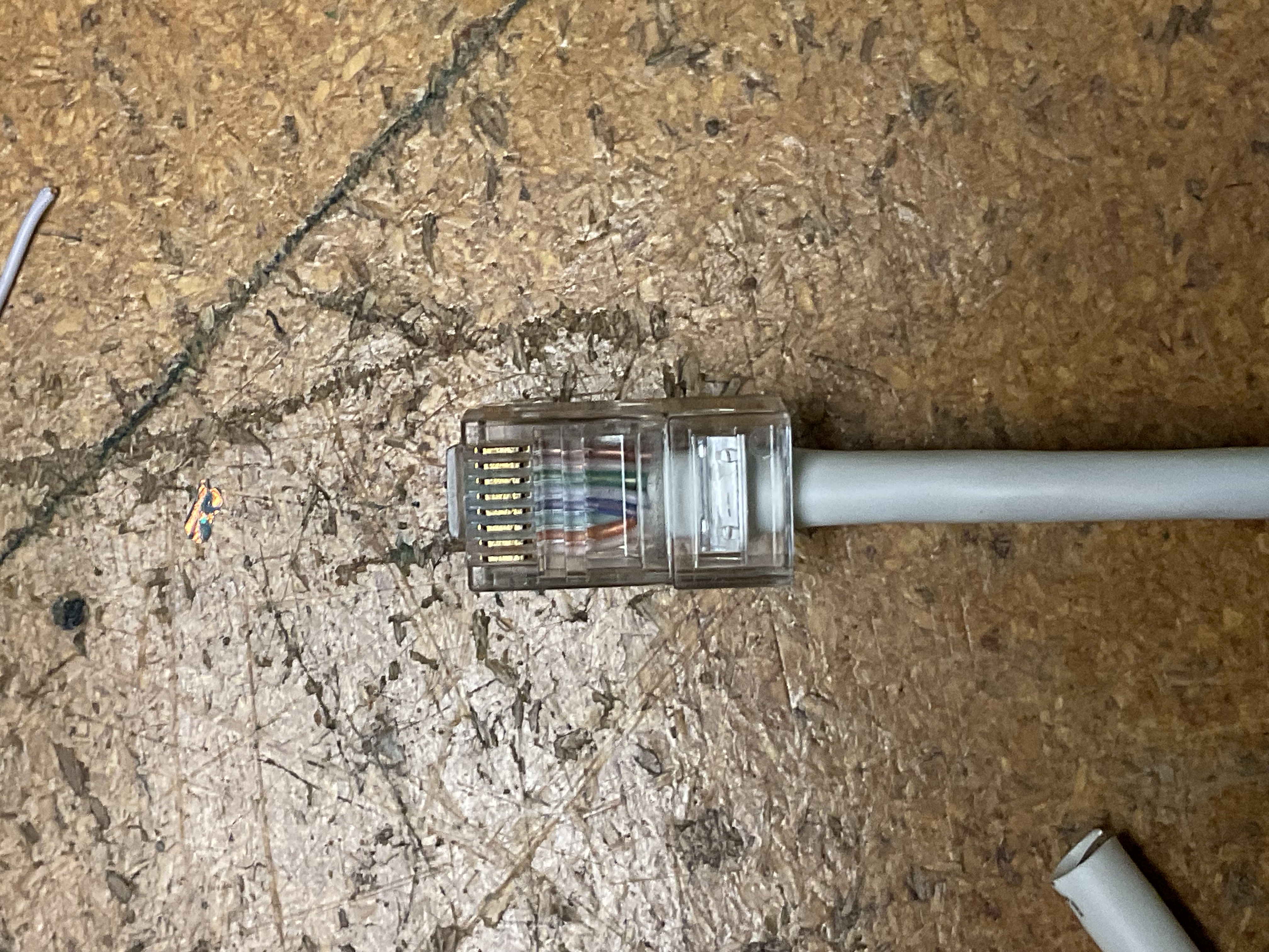RJ45 plug close-up showing T568B pin seating
