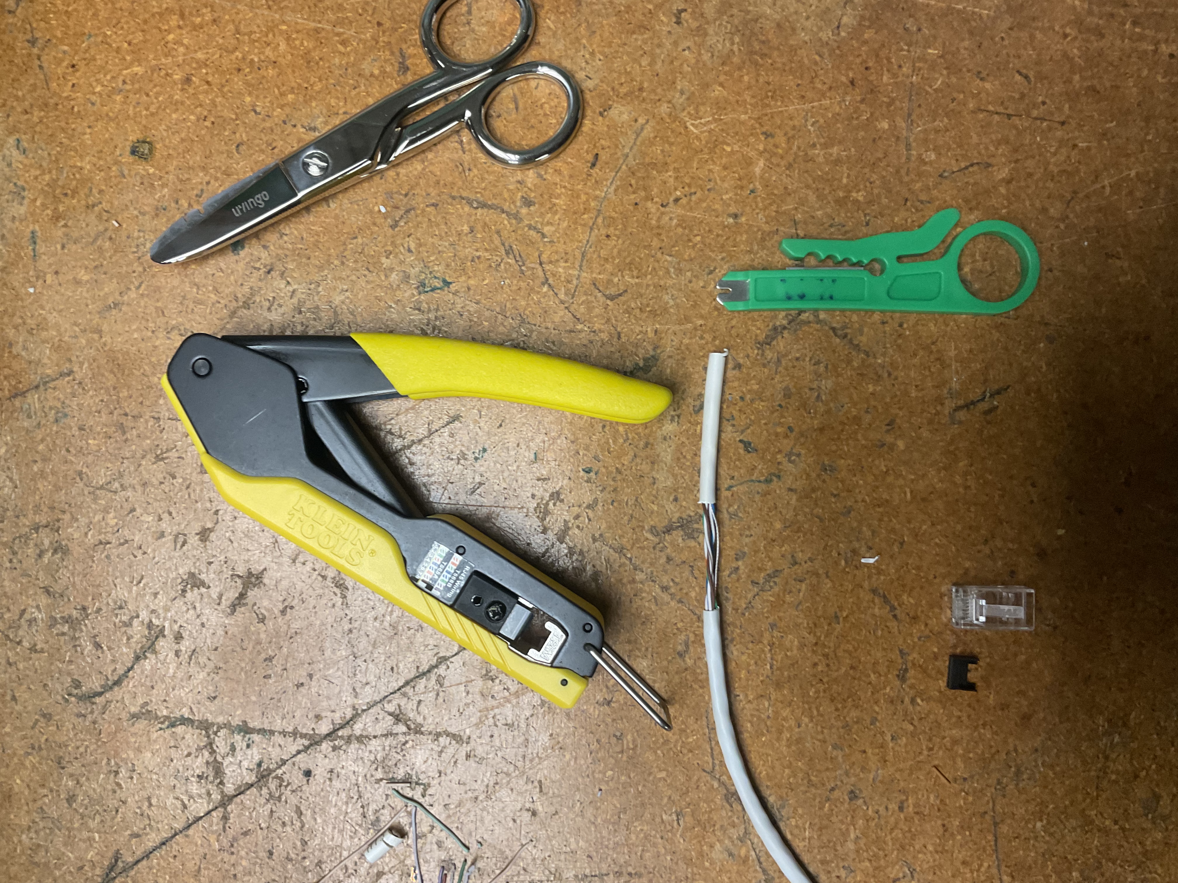 Klein ratcheting crimper and jacket stripper on bench