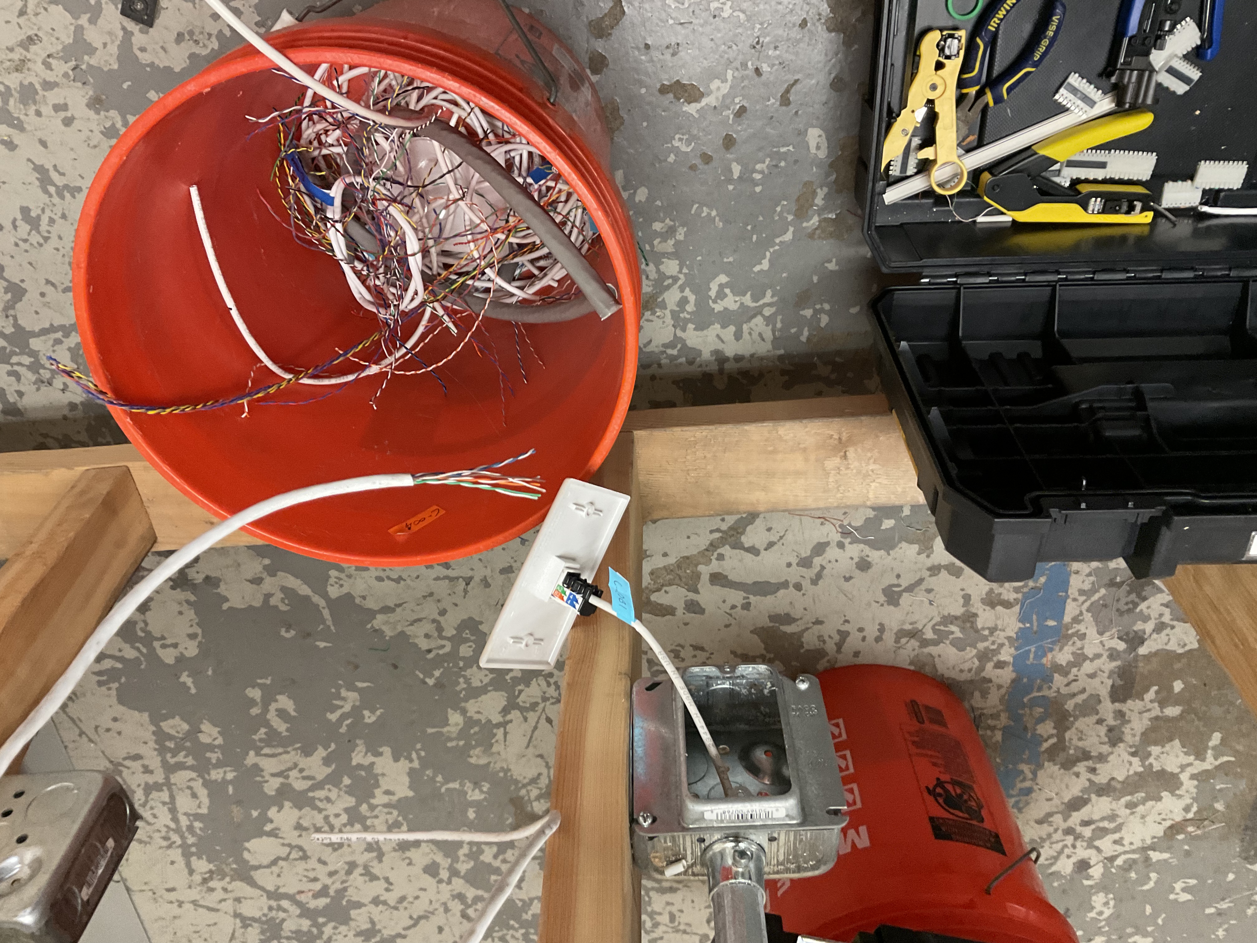 Worksite overview with toolbox, cable bucket and Hilti nailer